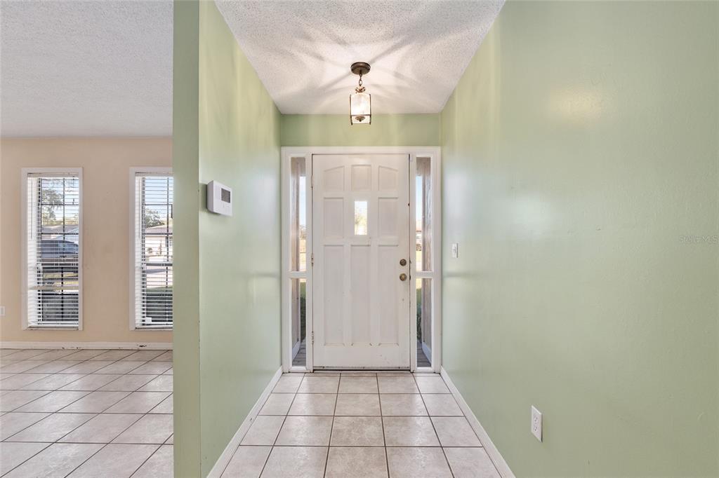 3300 Southeast 32nd Street Ocala, FL 34471 - Photo 6 of 51 a view of a hallway with windows and chandelier