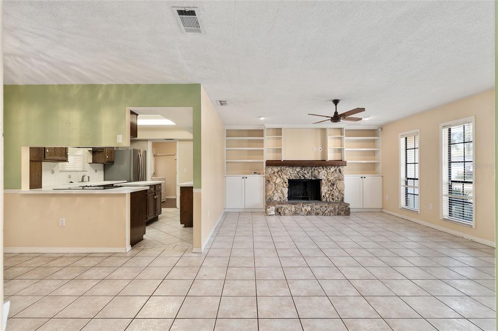 3300 Southeast 32nd Street Ocala, FL 34471 - Photo 7 of 51 a view of a kitchen with furniture a fireplace and windows