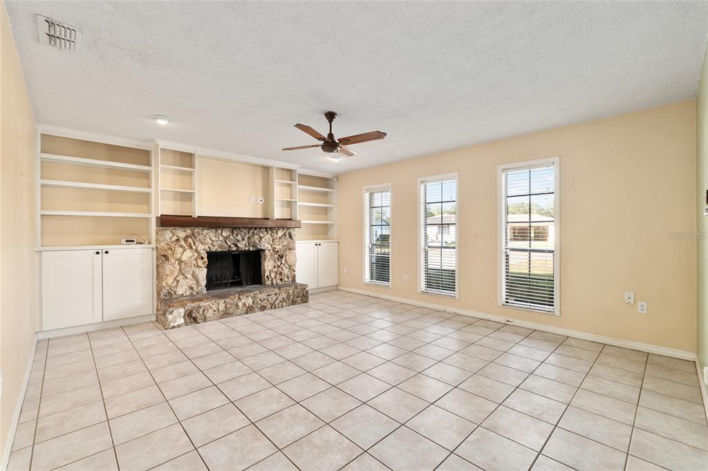 3300 Southeast 32nd Street Ocala, FL 34471 - Photo 8 of 51 a view of an empty room with a fireplace and a window