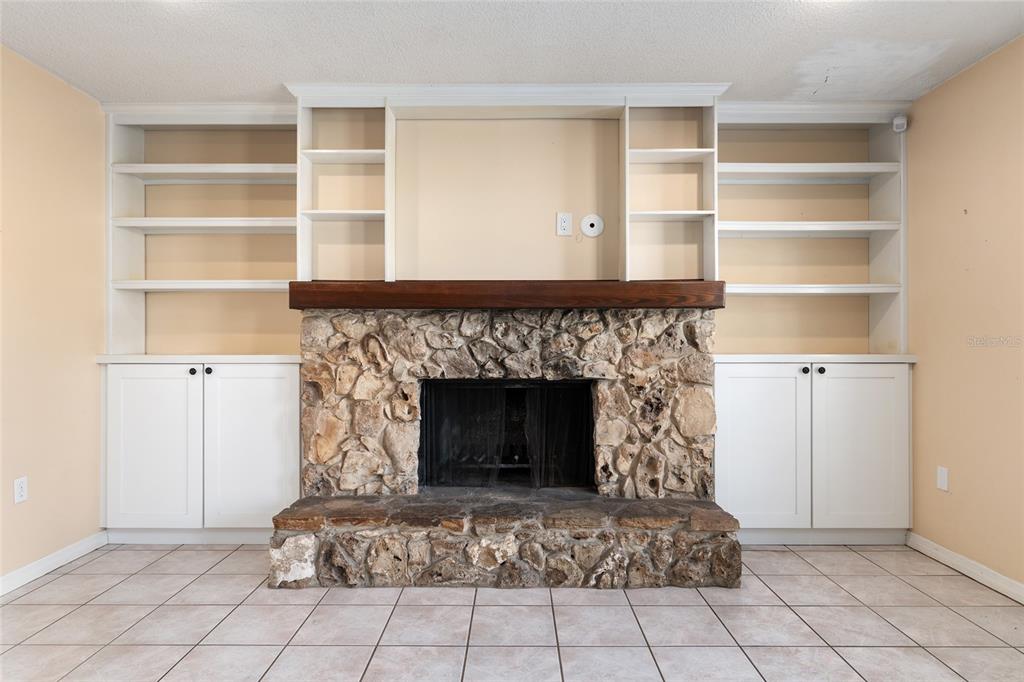 3300 Southeast 32nd Street Ocala, FL 34471 - Photo 10 of 51 a living room with a fireplace cabinet and a fireplace