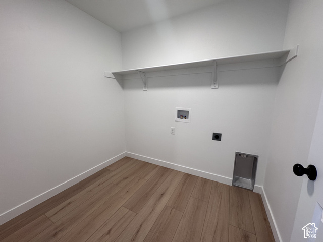 2613 Scarlet Road, Unit 258 Eagle Mountain, UT 84005 - Photo 25 of 30 Wood-finish flooring, white walls, built-in shelving, dryer vent, and appliance hookups