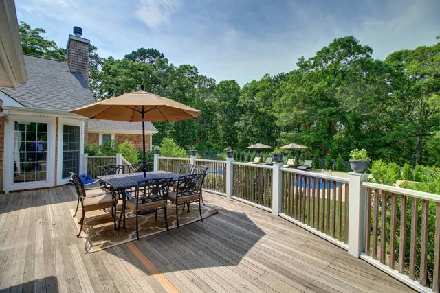 a view of a wooden deck with furniture