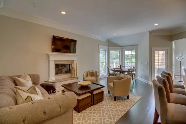 a living room with furniture fireplace and flat screen tv