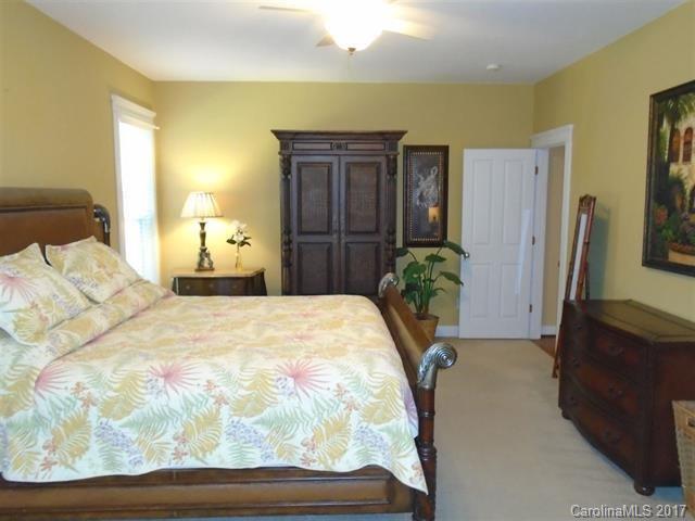 1512 Calvin Hall Road, Unit 161 Lake Wylie, SC 29710 - Photo 12 of 24 a bedroom with a bed dresser and a potted plant