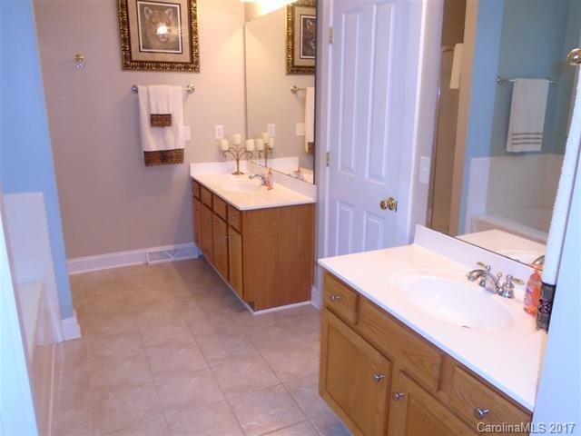 1512 Calvin Hall Road, Unit 161 Lake Wylie, SC 29710 - Photo 13 of 24 a bathroom with a sink a vanity and a mirror