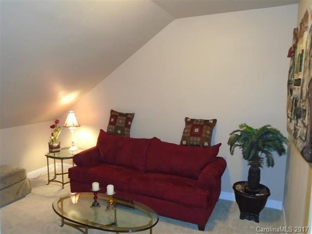 1512 Calvin Hall Road, Unit 161 Lake Wylie, SC 29710 - Photo 17 of 24 a living room with furniture potted plant and a lamp