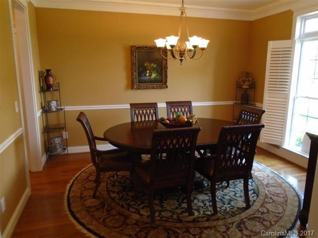 1512 Calvin Hall Road, Unit 161 Lake Wylie, SC 29710 - Photo 3 of 24 a view of a dining room with furniture and wooden floor