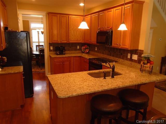 1512 Calvin Hall Road, Unit 161 Lake Wylie, SC 29710 - Photo 5 of 24 a kitchen with stainless steel appliances granite countertop sink stove and refrigerator