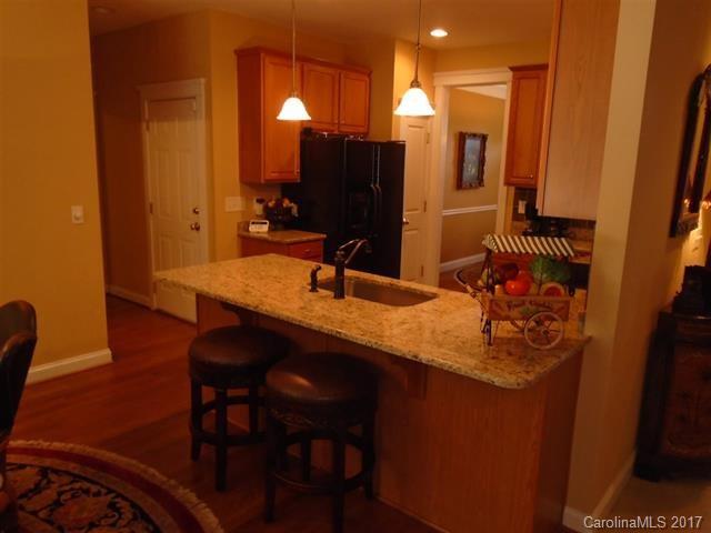 1512 Calvin Hall Road, Unit 161 Lake Wylie, SC 29710 - Photo 6 of 24 a room with a table chairs and a kitchen