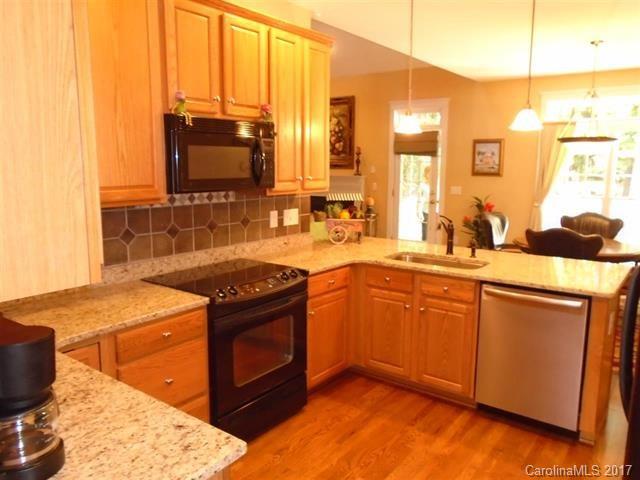1512 Calvin Hall Road, Unit 161 Lake Wylie, SC 29710 - Photo 7 of 24 a kitchen with stainless steel appliances granite countertop a sink stove and microwave