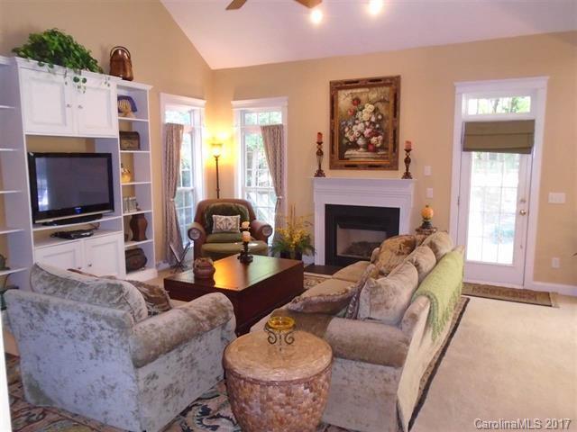 1512 Calvin Hall Road, Unit 161 Lake Wylie, SC 29710 - Photo 9 of 24 a living room with furniture a fireplace and a flat screen tv