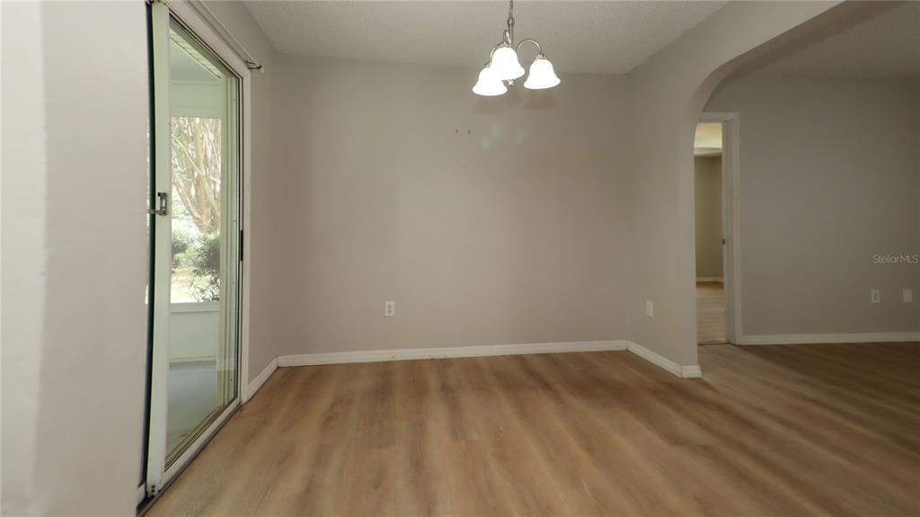 10860 Southwest 62nd Avenue Ocala, FL 34476 - Photo 13 of 35 wooden floor in an empty room with a window