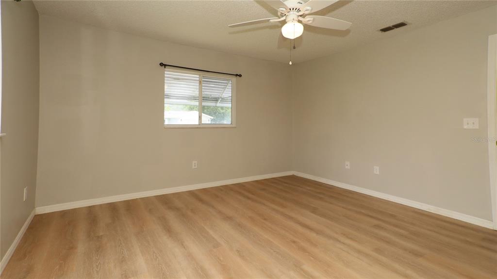 10860 Southwest 62nd Avenue Ocala, FL 34476 - Photo 28 of 35 wooden floor in an empty room with a window