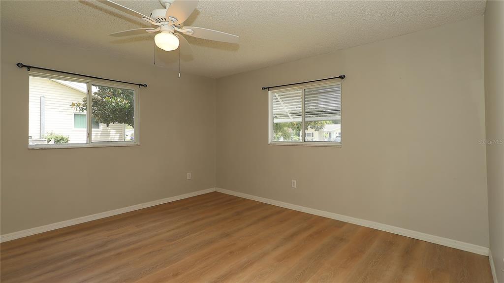 10860 Southwest 62nd Avenue Ocala, FL 34476 - Photo 31 of 35 a view of empty room with wooden floor and fan