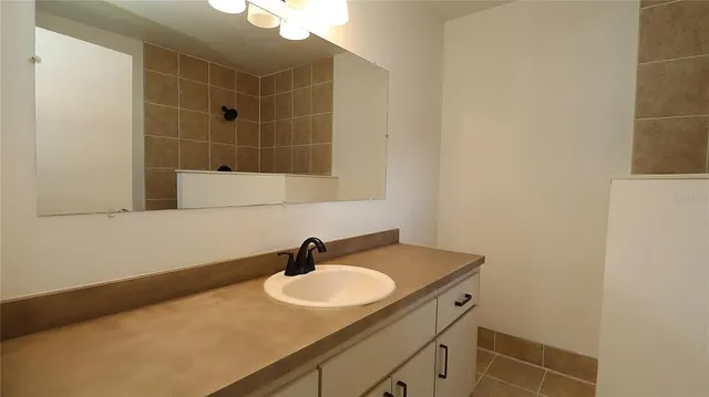 a bathroom with a sink and mirror