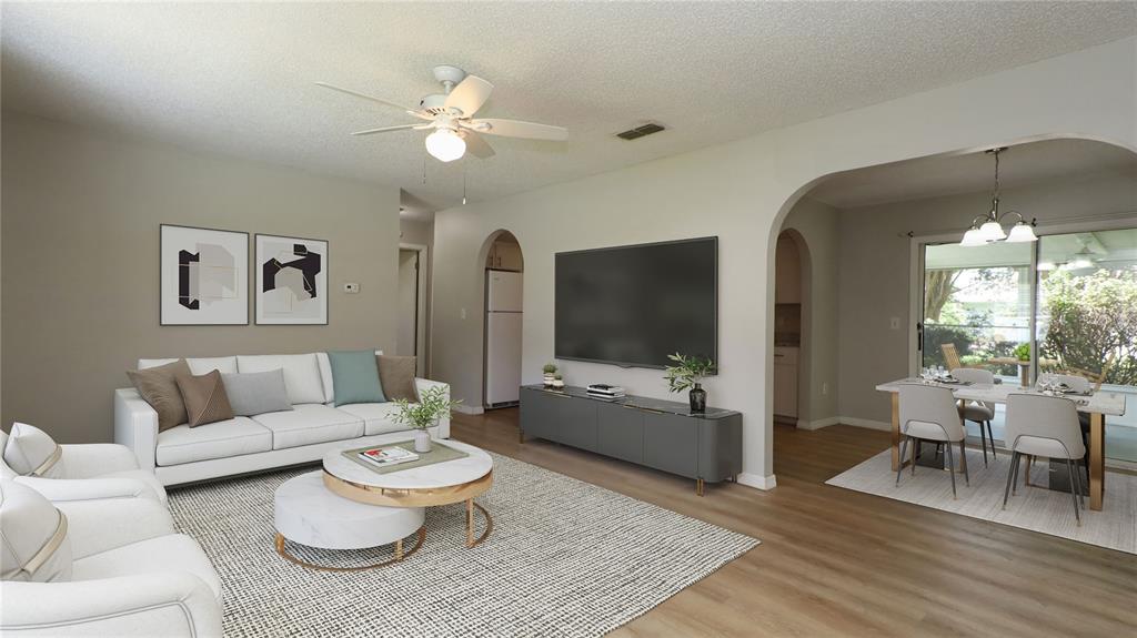 10860 Southwest 62nd Avenue Ocala, FL 34476 - Photo 7 of 35 a living room with furniture and a large window