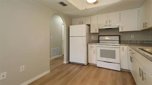 a view of a kitchen with electric appliances