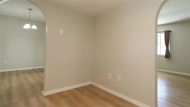 a view of a room with wooden floor