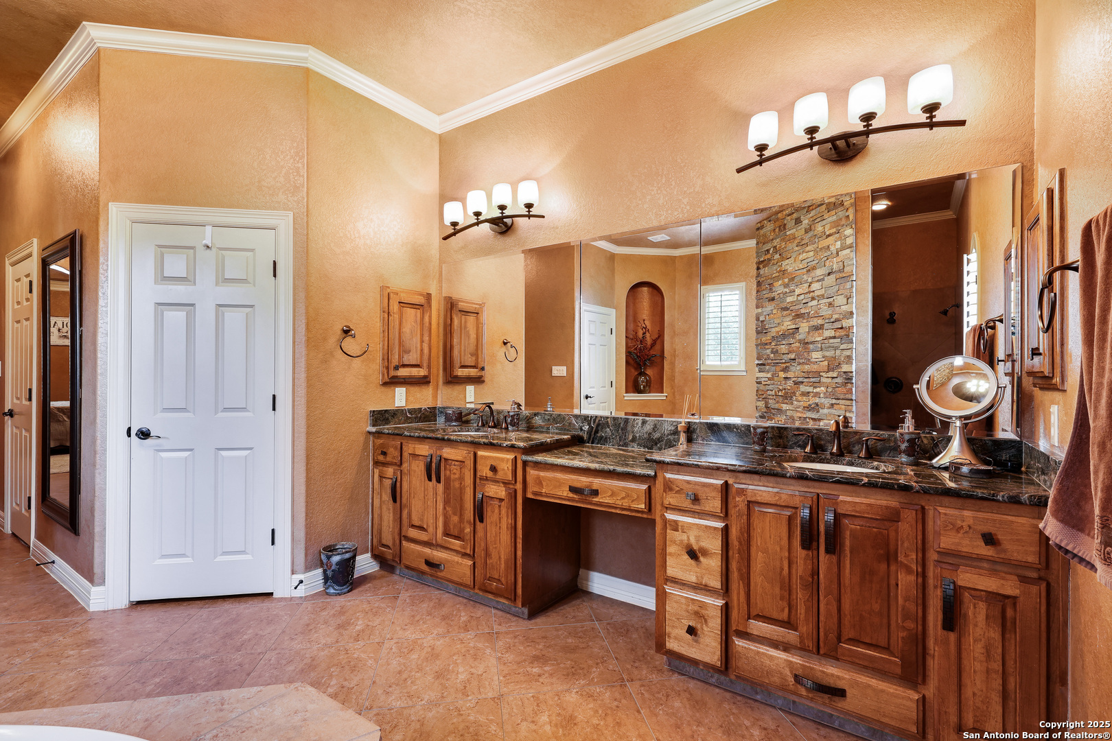 315 Santa Domingo Helotes, TX 78023 - Photo 22 of 50 a spacious bathroom with a granite countertop double vanity and a mirror