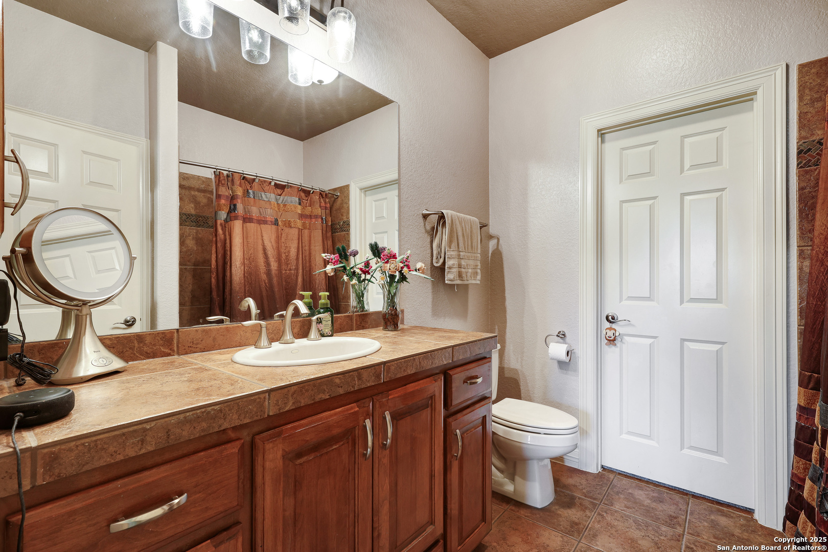 315 Santa Domingo Helotes, TX 78023 - Photo 36 of 50 a bathroom with a toilet a sink and a mirror