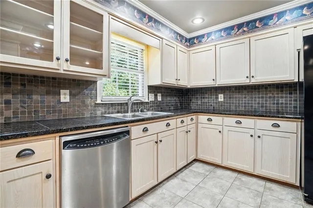 a kitchen with granite countertop a sink and a stove