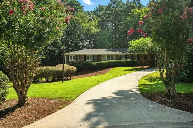 a view of a house with a backyard