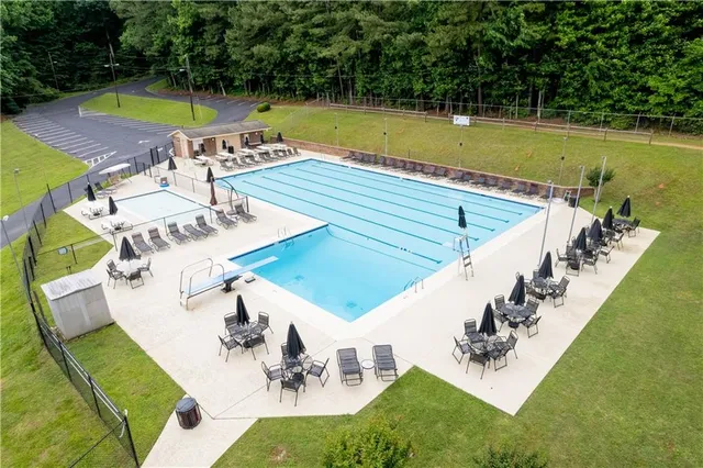 a view of a tennis ground with large trees