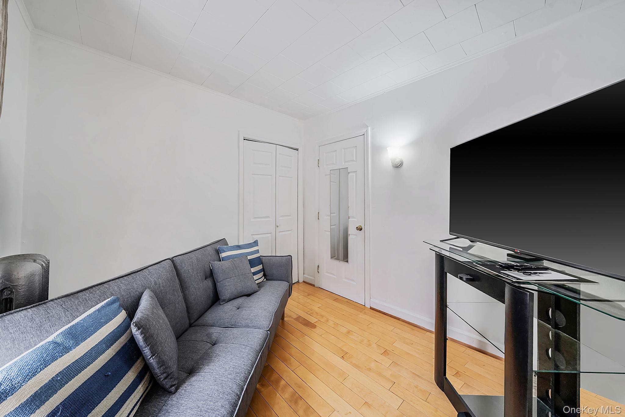 93-20 92nd Avenue Queens, NY 11421 - Photo 13 of 21 a living room with furniture and a flat screen tv