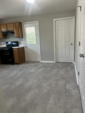 a view of a kitchen with an empty space and a window