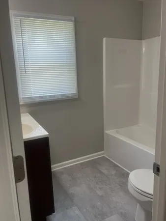 a bathroom with a toilet a sink and a bathtub