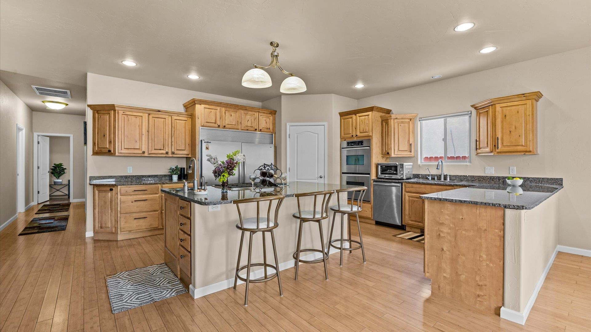 1712 Powis Lane Fruita, CO 81521 - Photo 10 of 39 a kitchen with white cabinets and stainless steel appliances