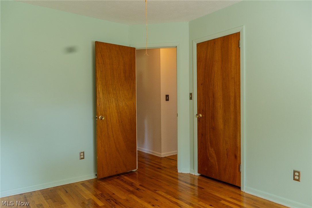 2848 Pressler Road Uniontown, OH 44685 - Photo 14 of 37 Hardwood flooring with a natural finish, solid wood interior doors, and painted walls