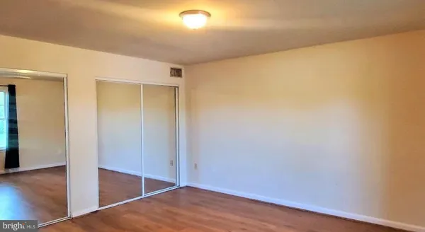 a view of hallway with wooden floor