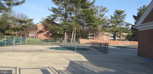 a backyard of apartments with large trees