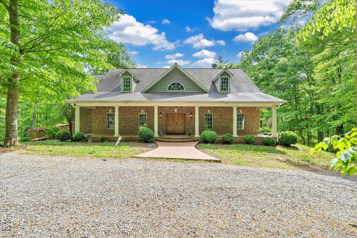 a front view of a house with a yard and porch