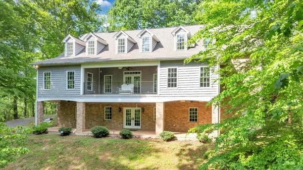 a view of a porch with wooden floor and a yard