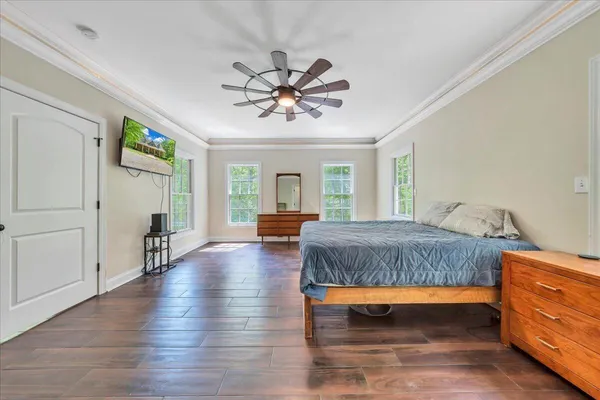 a bedroom with furniture and a wooden floor