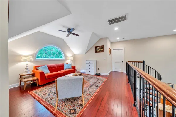 a living room with furniture and a wooden floor