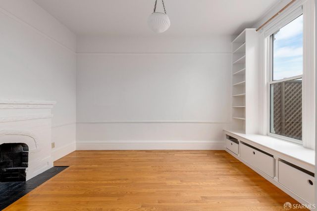 a view of an empty room with a fireplace