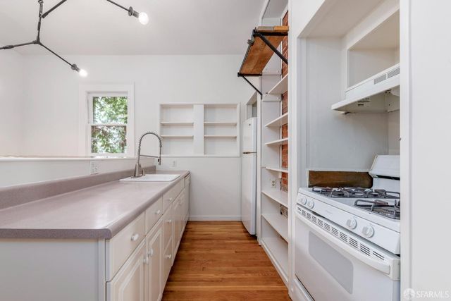 a kitchen with stainless steel appliances granite countertop a sink and cabinets