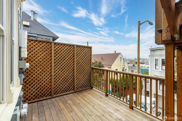 a view of a balcony with wooden floor