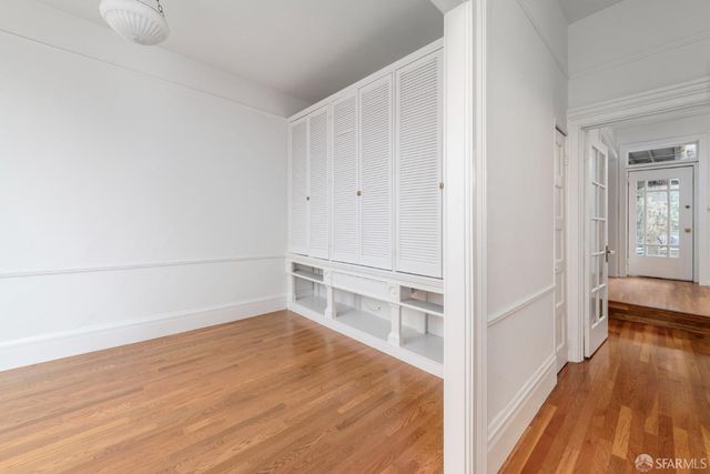 a view of a room with wooden floor