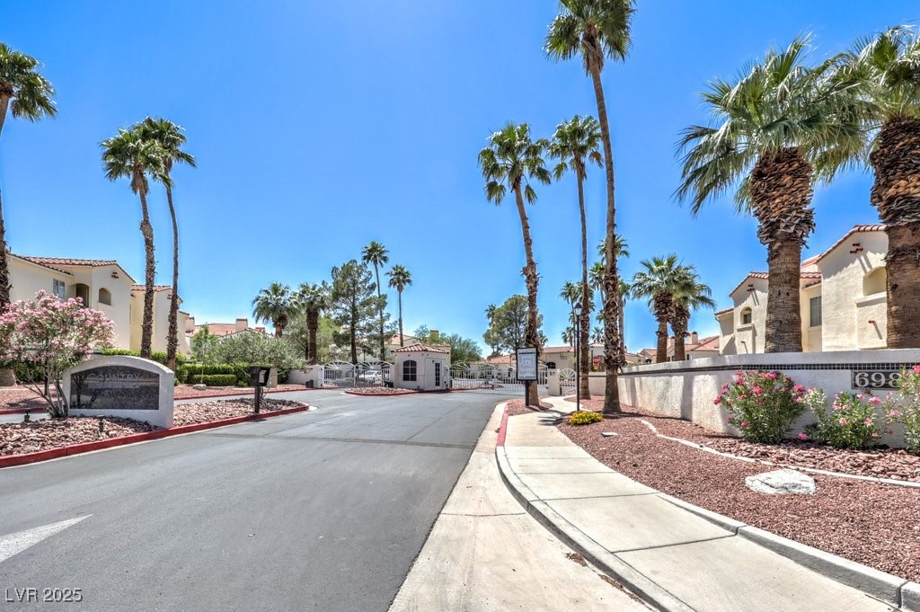 698 South Racetrack Road, Unit 1014 Henderson, NV 89015 - Photo 24 of 25 View of asphalt road with sidewalks, curbs, a residential view, and a gated entry