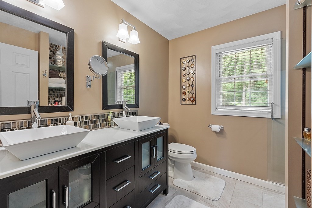 55 Rowley Hill Road Sterling, MA 01564 - Photo 23 of 42 a bathroom with a granite countertop toilet sink and mirror