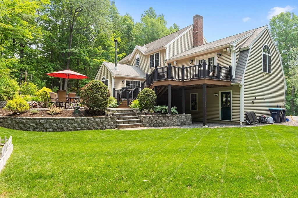 55 Rowley Hill Road Sterling, MA 01564 - Photo 35 of 42 a front view of a house with a garden and trees