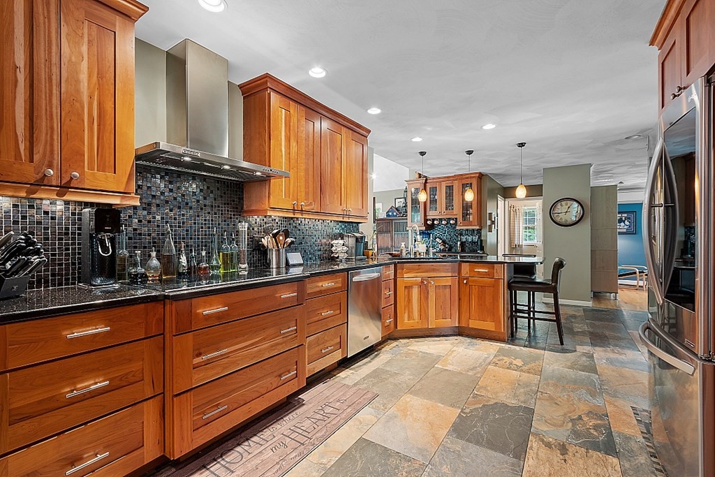 55 Rowley Hill Road Sterling, MA 01564 - Photo 10 of 42 a kitchen with granite countertop wooden cabinets a sink a window and stainless steel appliances
