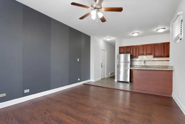a view of a kitchen with a sink and a refrigerator