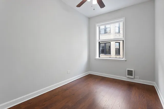 a view of a room with wooden floor and windows