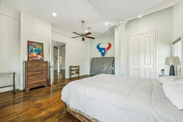 a bedroom with a bed and a view of kitchen