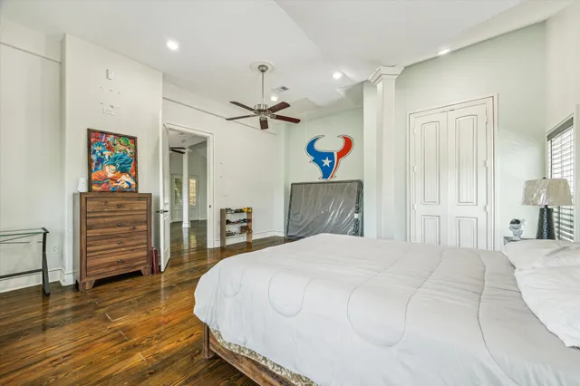 a bedroom with a bed and a view of kitchen